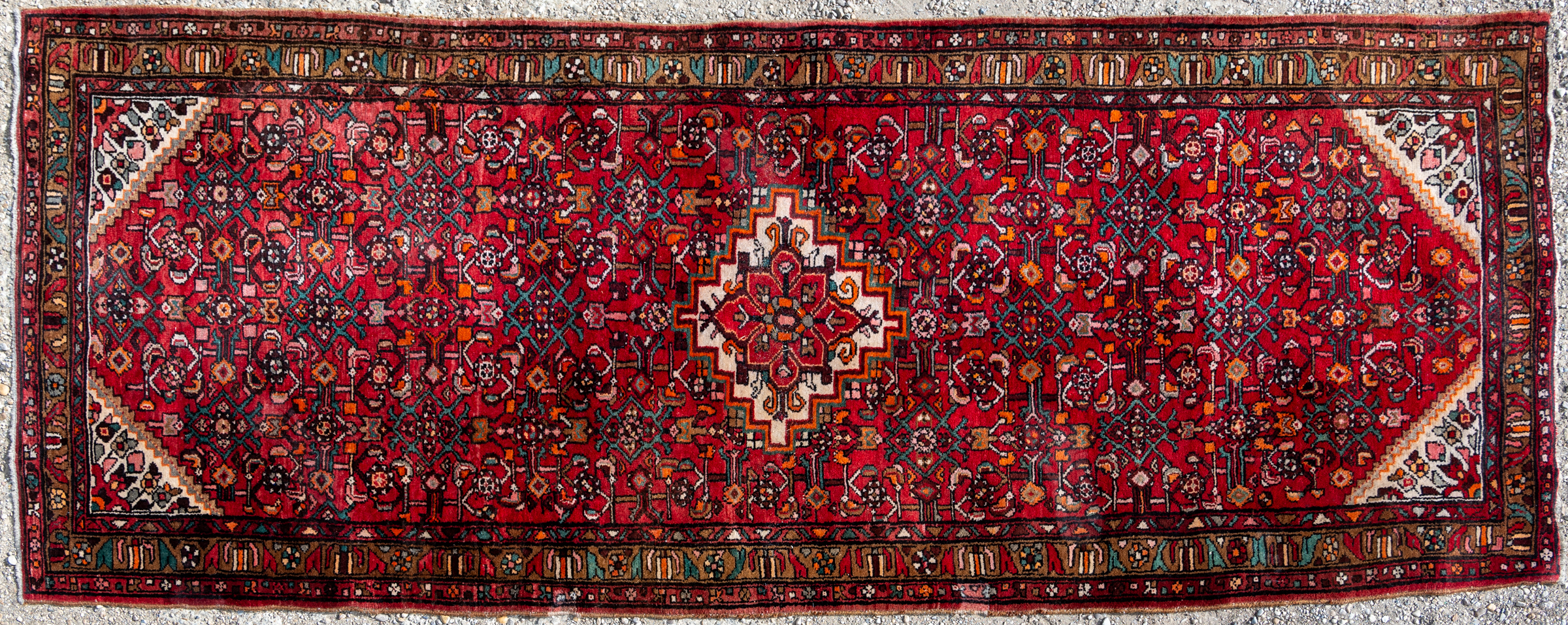 Appraisal: A modern red ground tribal rug with central white stepped