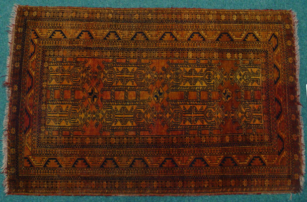 Appraisal: Rectangular orange and brown ground rug decorated with black geometric