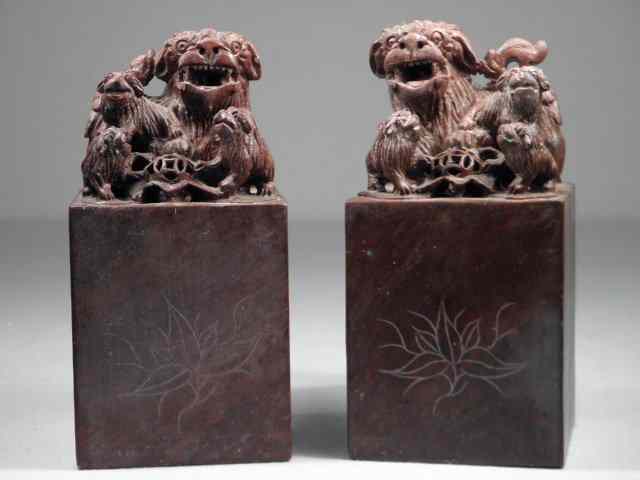 Appraisal: Pair of Chinese carved soapstone foo dog bookends Pierced red