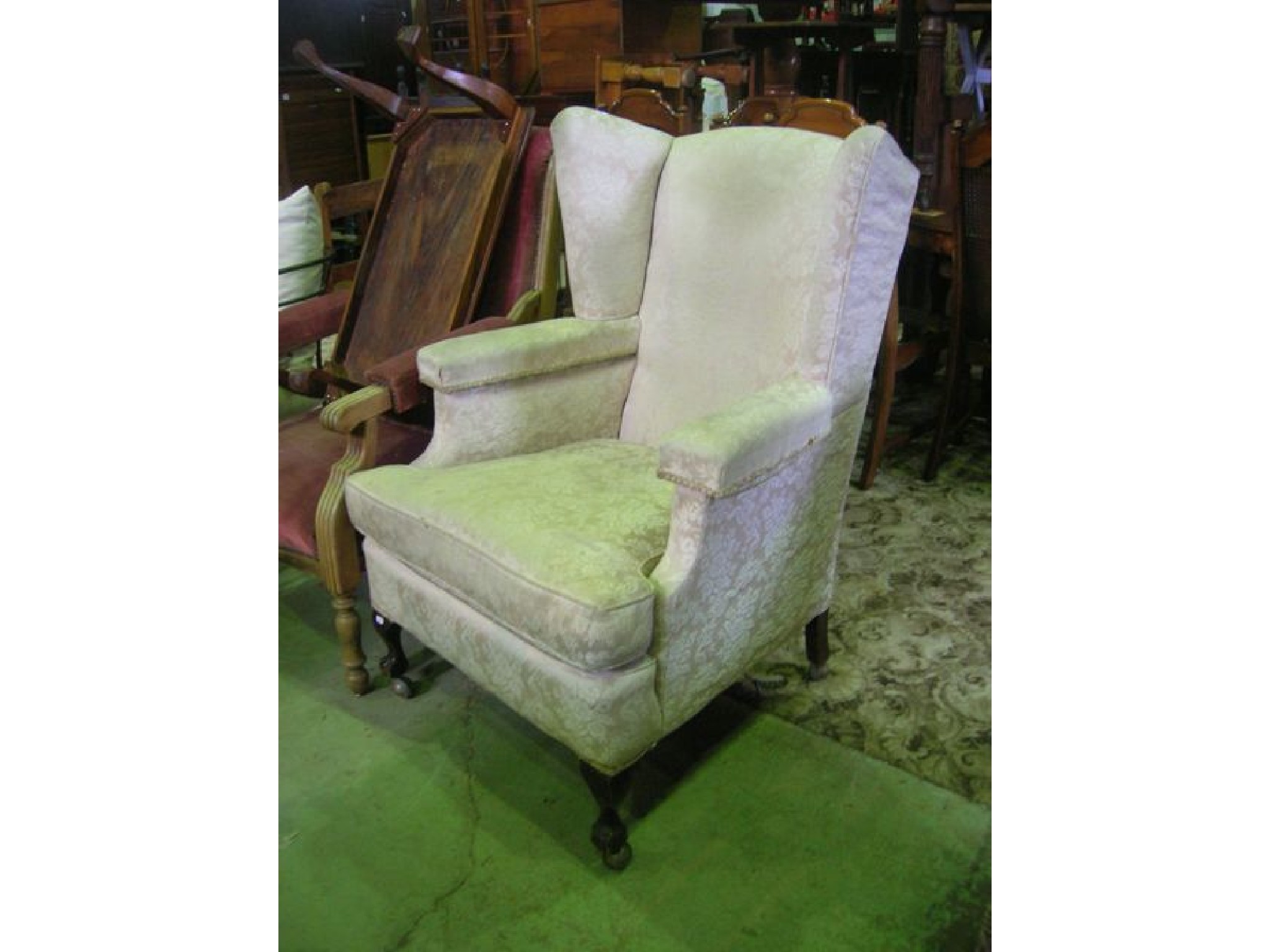 Appraisal: An Edwardian s wing armchair with floral upholstered finish on