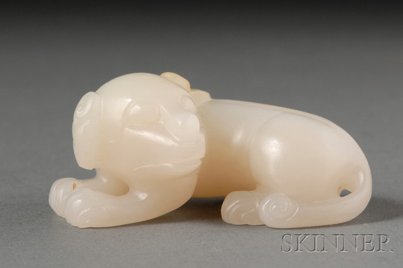 Appraisal: Jade Carving of a Reclining Dog gray-white stone ht in