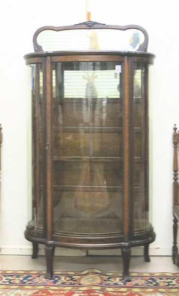 Appraisal: AN OAK AND CURVED GLASS CHINA DISPLAY CABINET American c