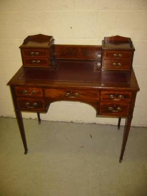 Appraisal: A LADY'S EDWARDIAN MAHOGANY DESK crossbanded with stringing the moulded