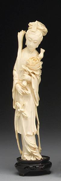 Appraisal: An ivory carving of a beauty Shown holding a peony