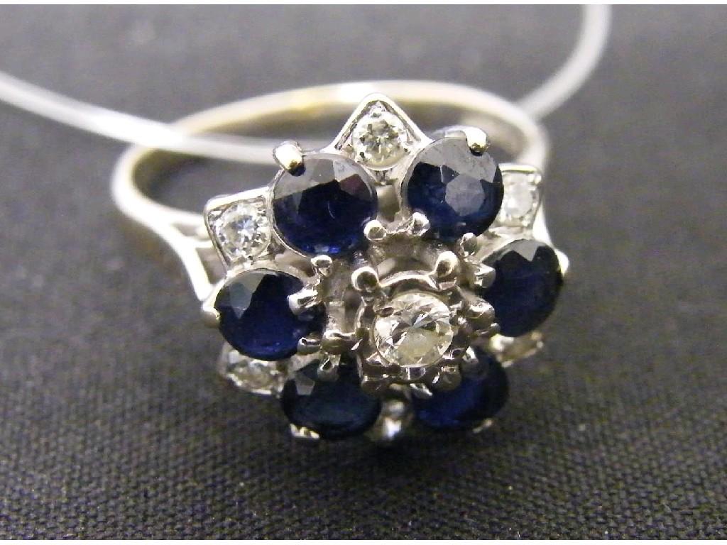 Appraisal: Unusual ct sapphire and diamond cluster ring the central diamond