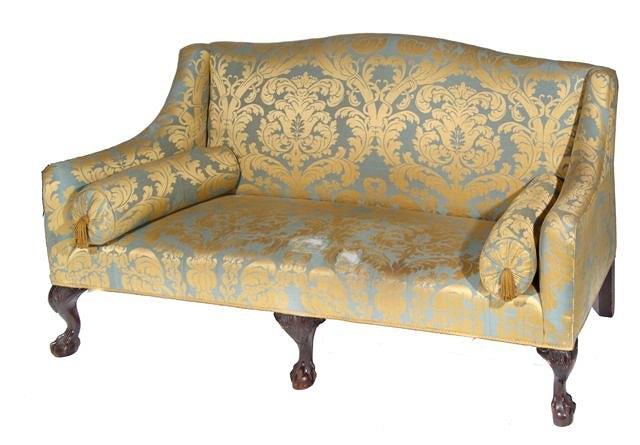 Appraisal: A GEORGIAN STYLE SOFA with figured upholstery on carved ball