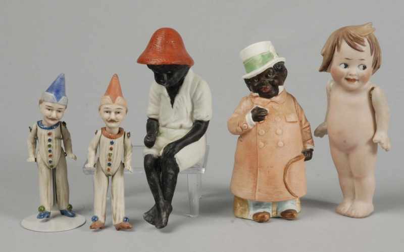 Appraisal: Lot of All-Bisque Characters Description Japan black sitting boy German