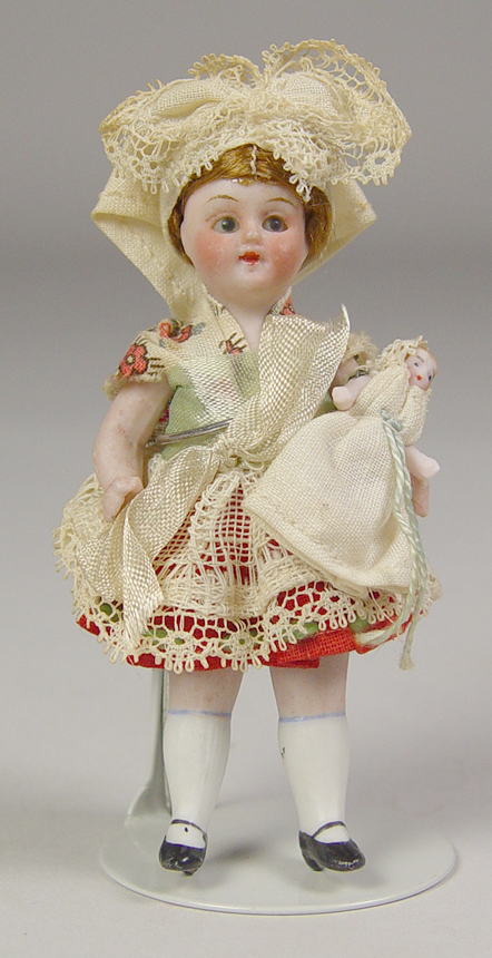 Appraisal: German All-Bisque Girl with Doll Blue glass eyes single stroke