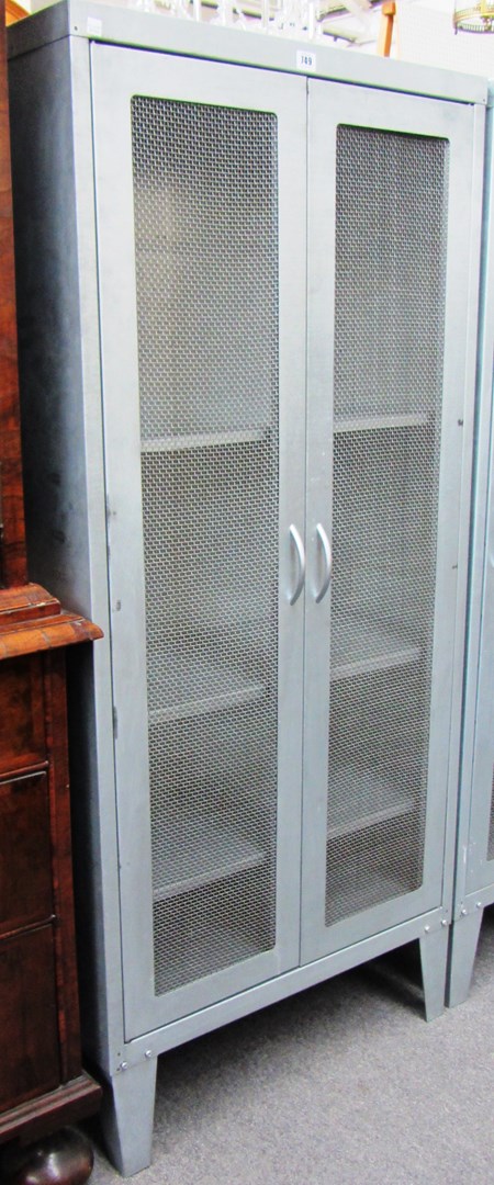 Appraisal: A th century brushed steel two door cabinet on tapering