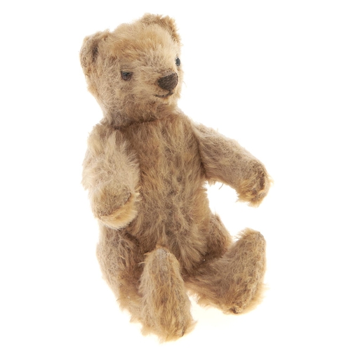 Appraisal: A miniature faded golden mohair teddy bear cm h More