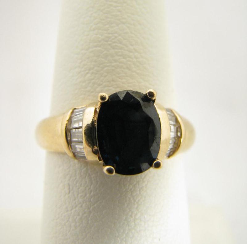 Appraisal: Lady's k Yellow Gold Oval Sapphire Baguette Diamond Ring