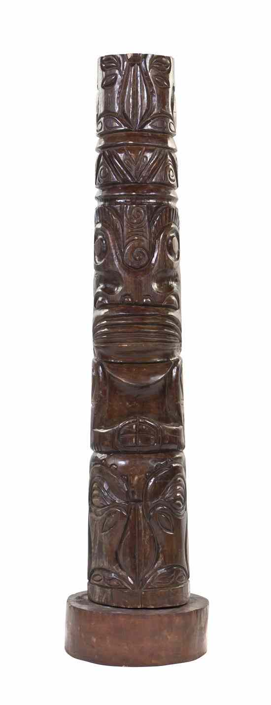 Appraisal: A Carved Wood Tiki Totem of tapering cylindrical form depicting