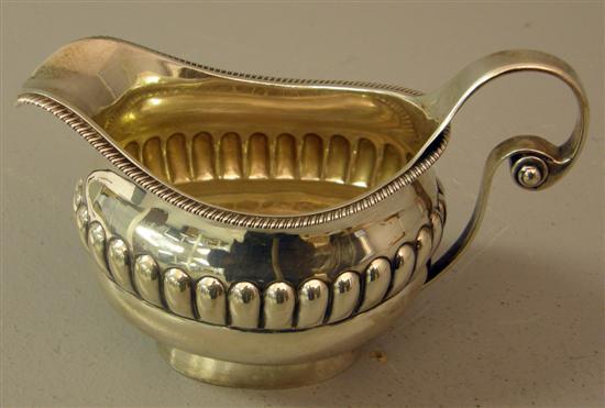 Appraisal: George III silver cream jug with gadrooned rim scrolled handle