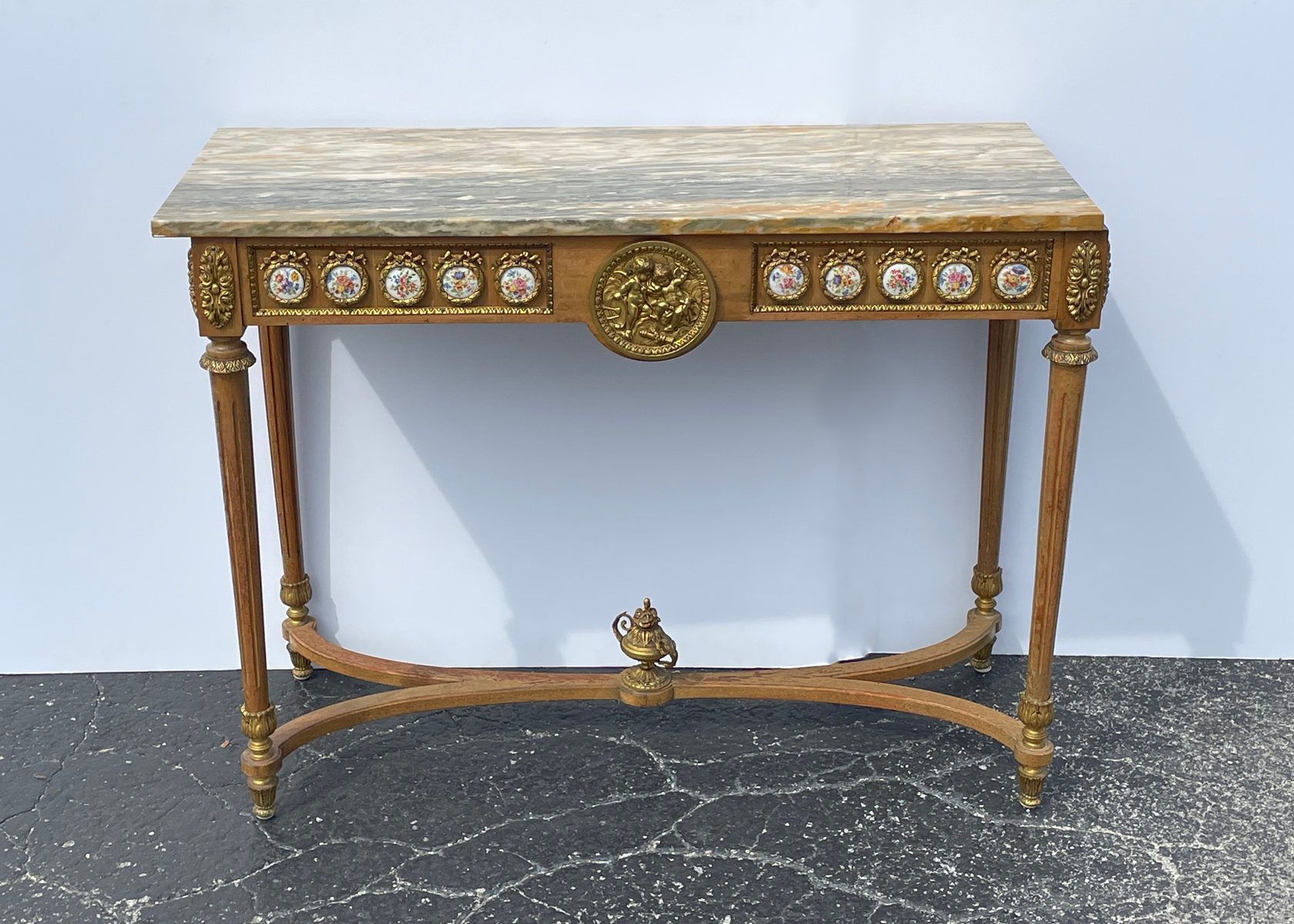 Appraisal: MARBLE TOP CONSOLE TABLE WITH PORCELAIN RHONDELS Hand-painted porcelain inserts