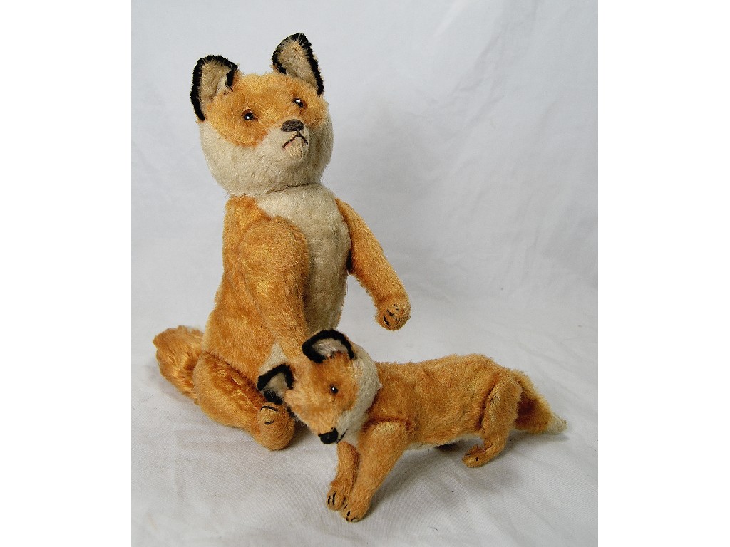 Appraisal: A gold plush stuffed toy fox with glass eyes stitched