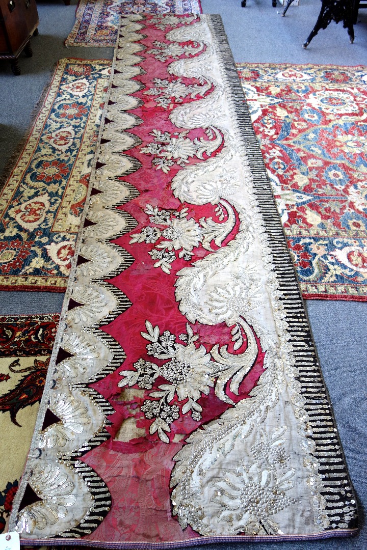 Appraisal: A maroon silk damask horizontal hanging possibly Russian th century