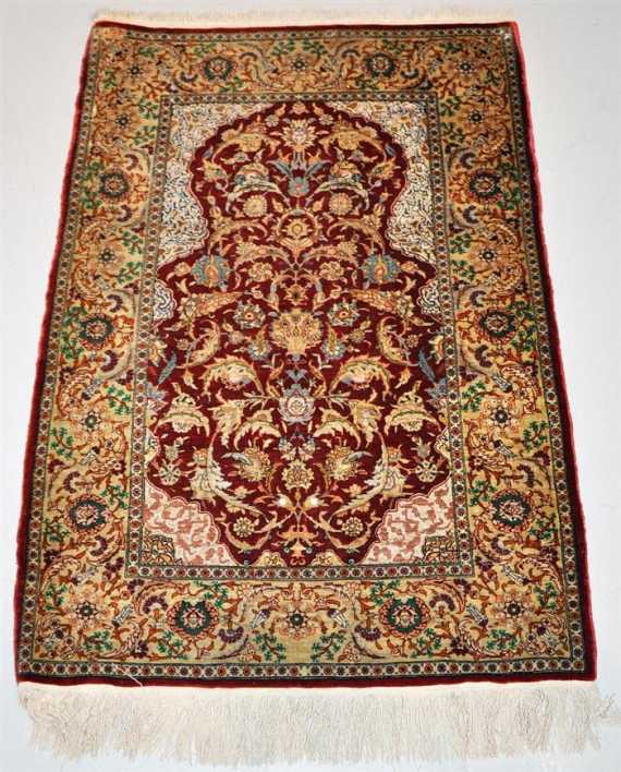 Appraisal: HEREKE SILK Red mihrab with light spandrels patterned with trailing