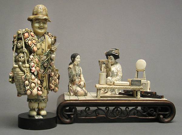 Appraisal: A Japanese style pieced ivory and wood figural group Depicting