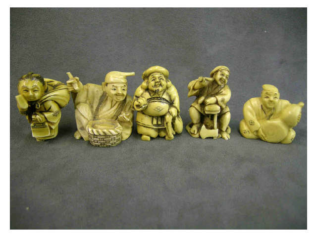 Appraisal: Five stained ivory netsuke including man with a basket and