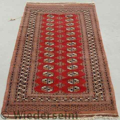 Appraisal: Bokhara oriental center hall carpet with geometric patterns and red