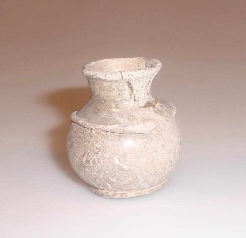 Appraisal: A small post-Roman heavily weathered ointment jar made in pale