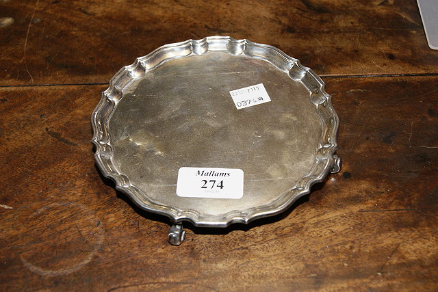 Appraisal: A SMALL SILVER CARD TRAY with pie-crust borders and scroll