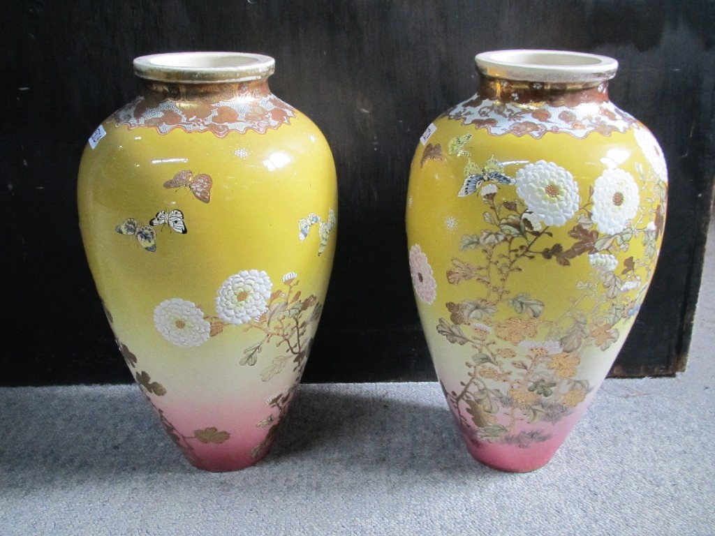 Appraisal: Pair of Japanese satsuma vases decorated with flowers and butterflies