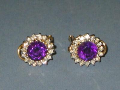 Appraisal: A PAIR OF AMETHYST AND DIAMOND CLUSTER EARRINGS the round