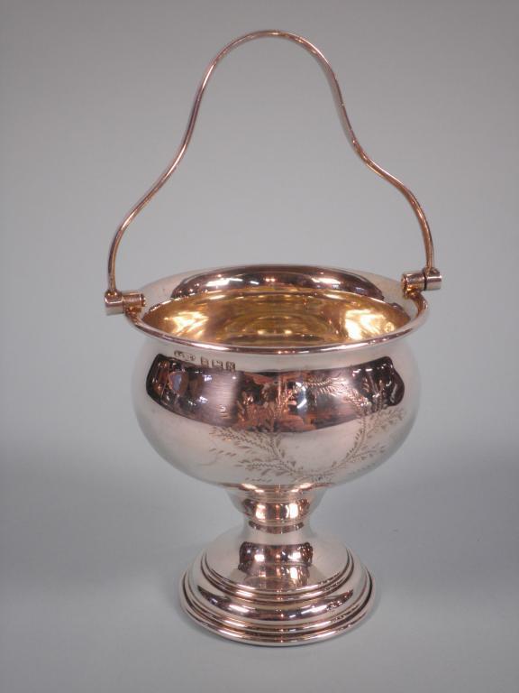 Appraisal: A silver sugar basket engraved with a floral cartouche and