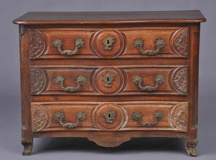 Appraisal: LOUIS XV PROVINCIAL CARVED WALNUT SERPENTINE-FRONTED COMMODE Containing three triple-paneled