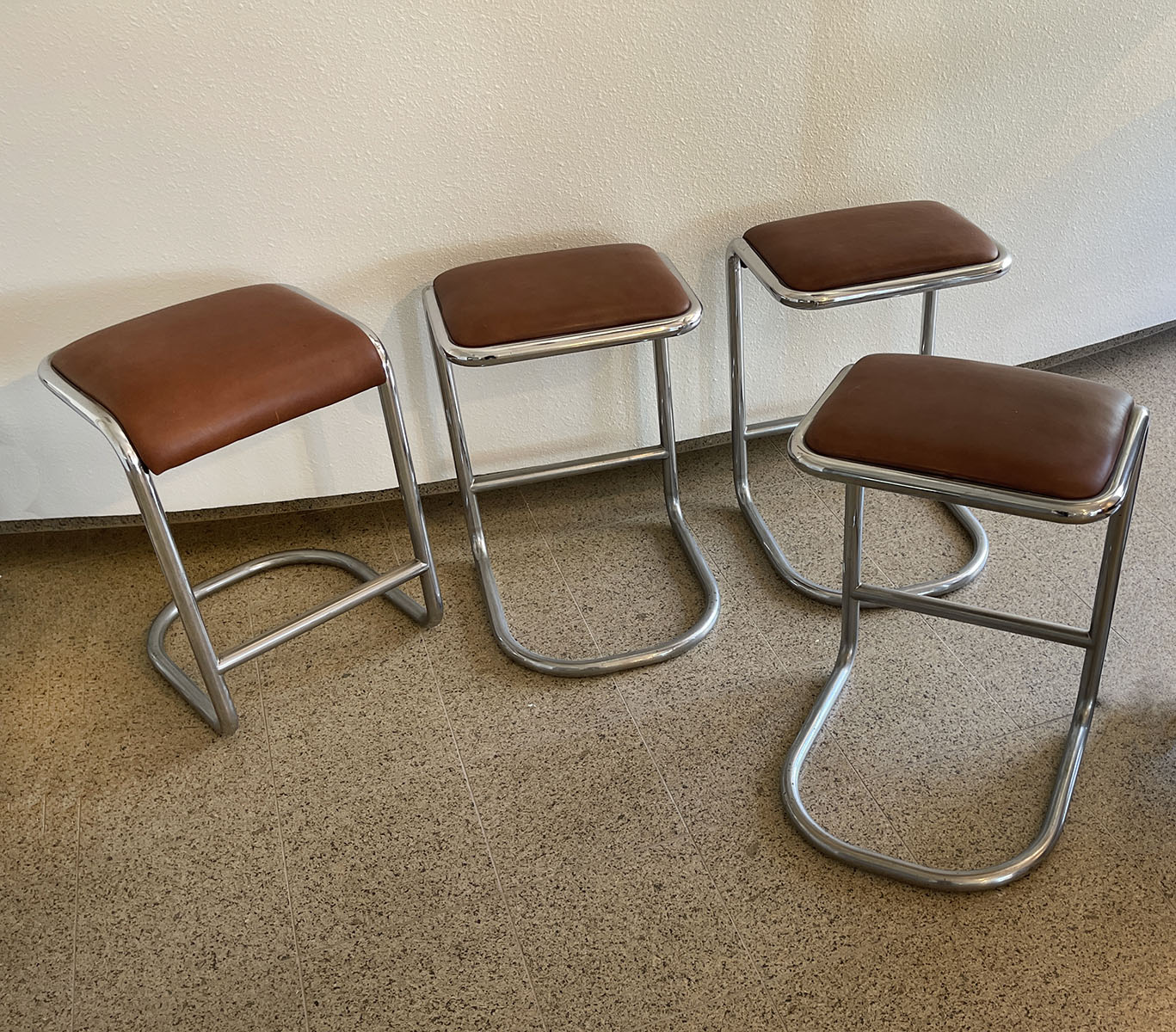 Appraisal: MID-CENTURY MODERN CHROMED LEATHER STOOLS All four having bent chromed