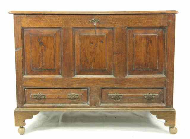 Appraisal: An oak mule chest with panelled front and two drawers