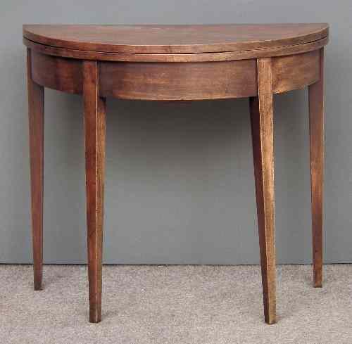 Appraisal: A George III mahogany semi-circular tea table with plain folding