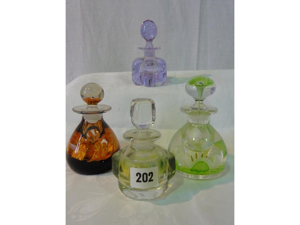 Appraisal: A collection of four Caithness glass bottles and stoppers including