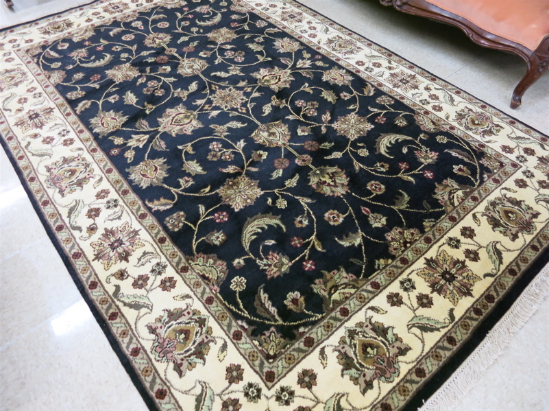 Appraisal: HAND KNOTTED ORIENTAL CARPET Indo-Kashan overall floral pattern on black