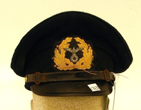 Appraisal: German dark blue bodied visor cap with proper insignia for