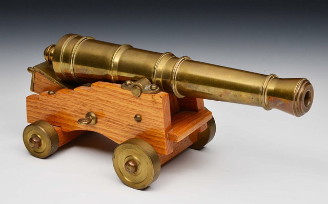 Appraisal: A BRASS TABLE TOP CANNON supported on a wooden carriage