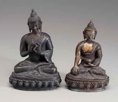 Appraisal: Two bronze Buddhas each seated on lotus thrones one wearing