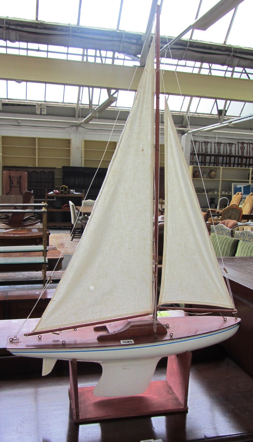 Appraisal: A wooden pond yacht with two sails and lead keel