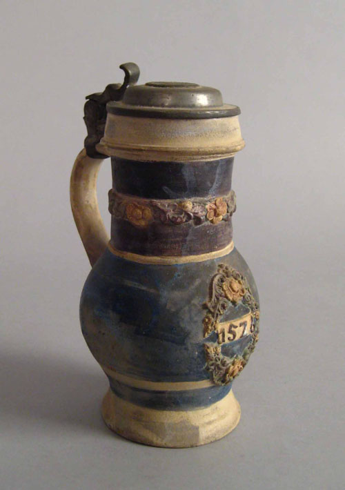 Appraisal: German stoneware tankard with pewter lid floral banding and cartouche