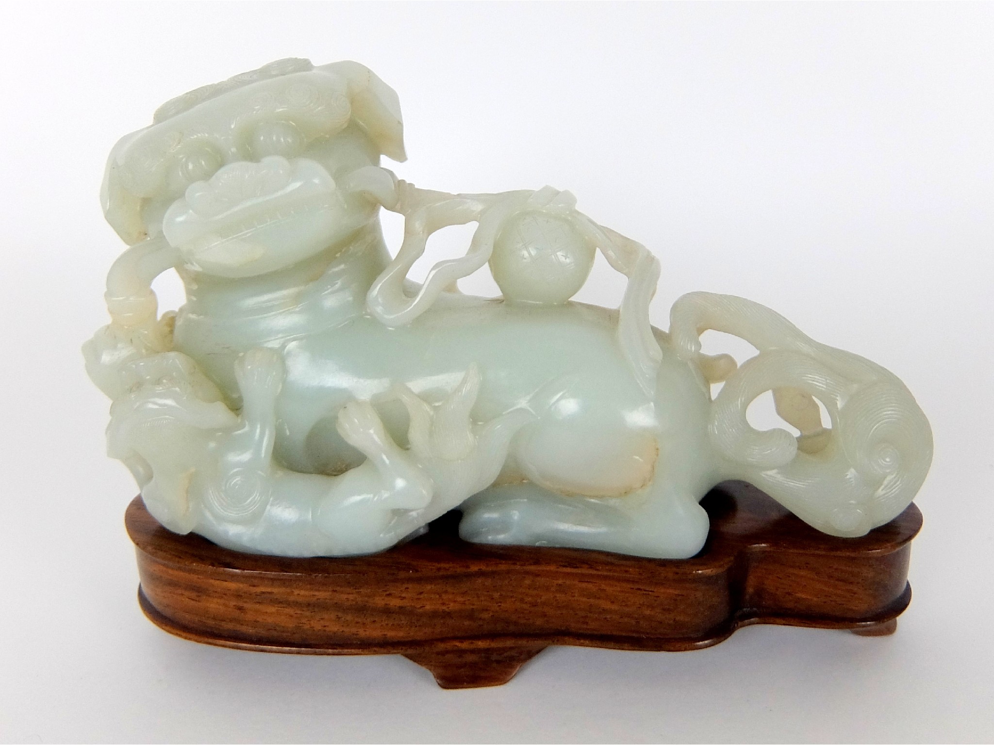 Appraisal: A Chinese jade buddhistic lion and cublying and playing with