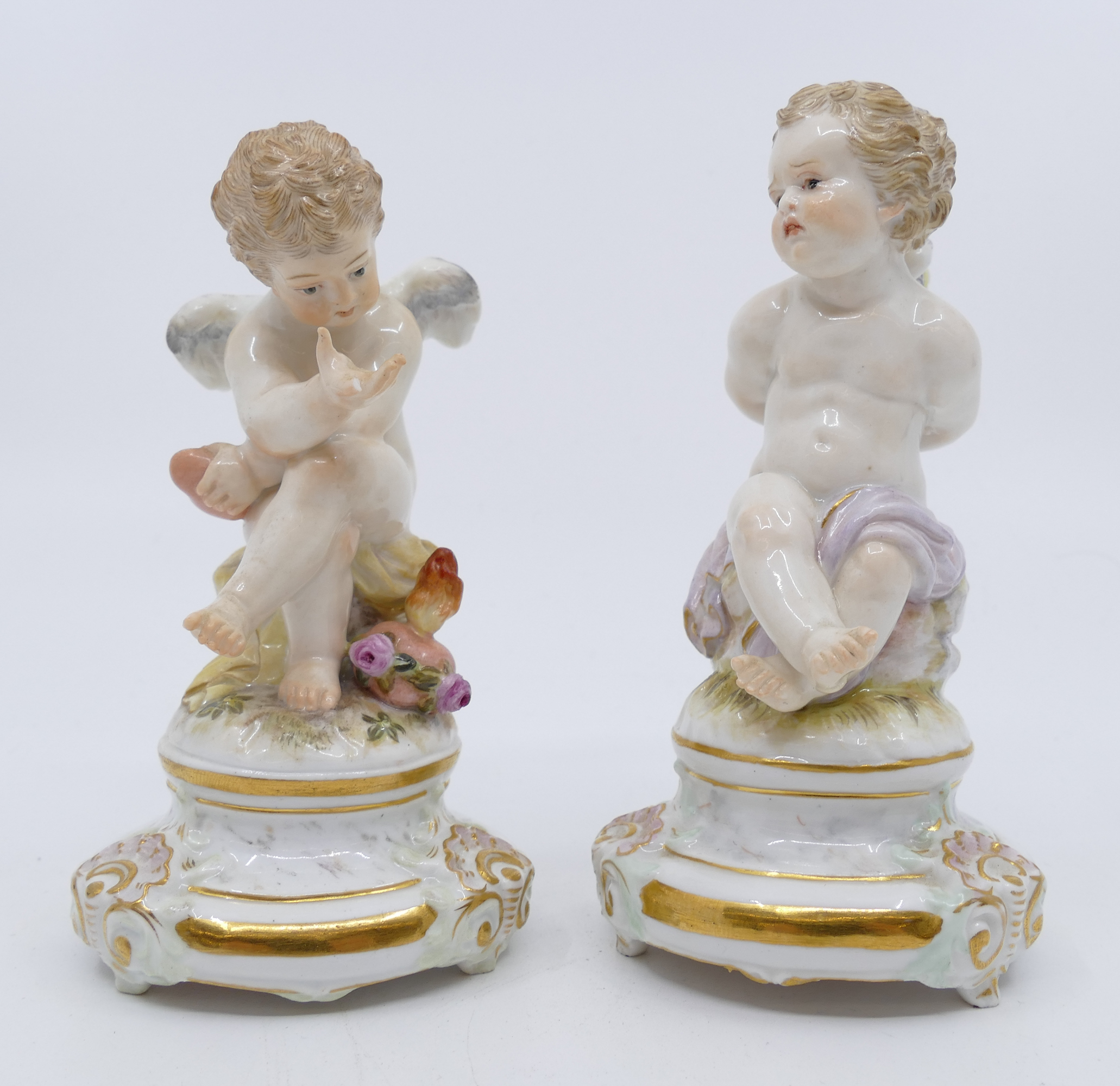 Appraisal: Pair Meissen Cupid Porcelain Figurines Models by Heinrich Schwabe -