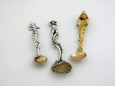 Appraisal: Three cast saltspoons a nautical example with coral stem by