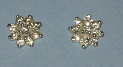 Appraisal: A PAIR OF DIAMOND CLUSTER EARRINGS of flowerhead form comprising