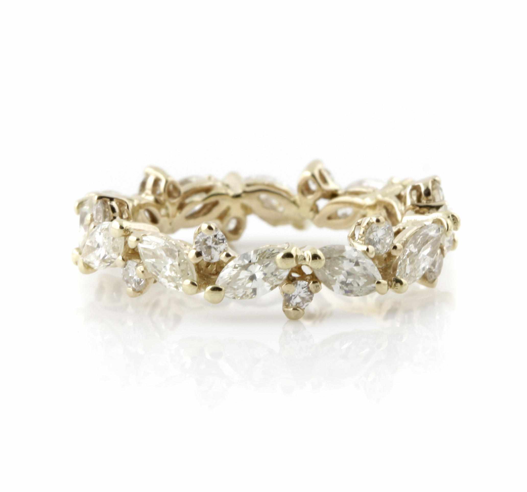 Appraisal: A diamond and gold eternity band featuring alternating marquise and