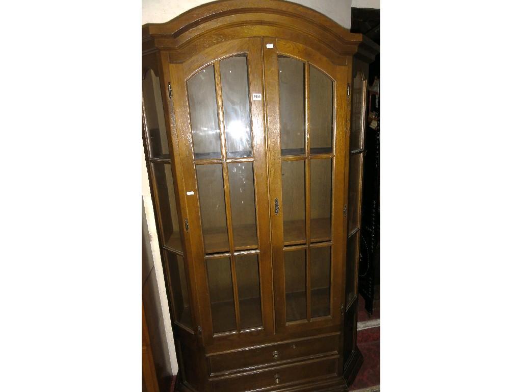 Appraisal: A reproduction oak display cabinet in the Dutch style enclosed