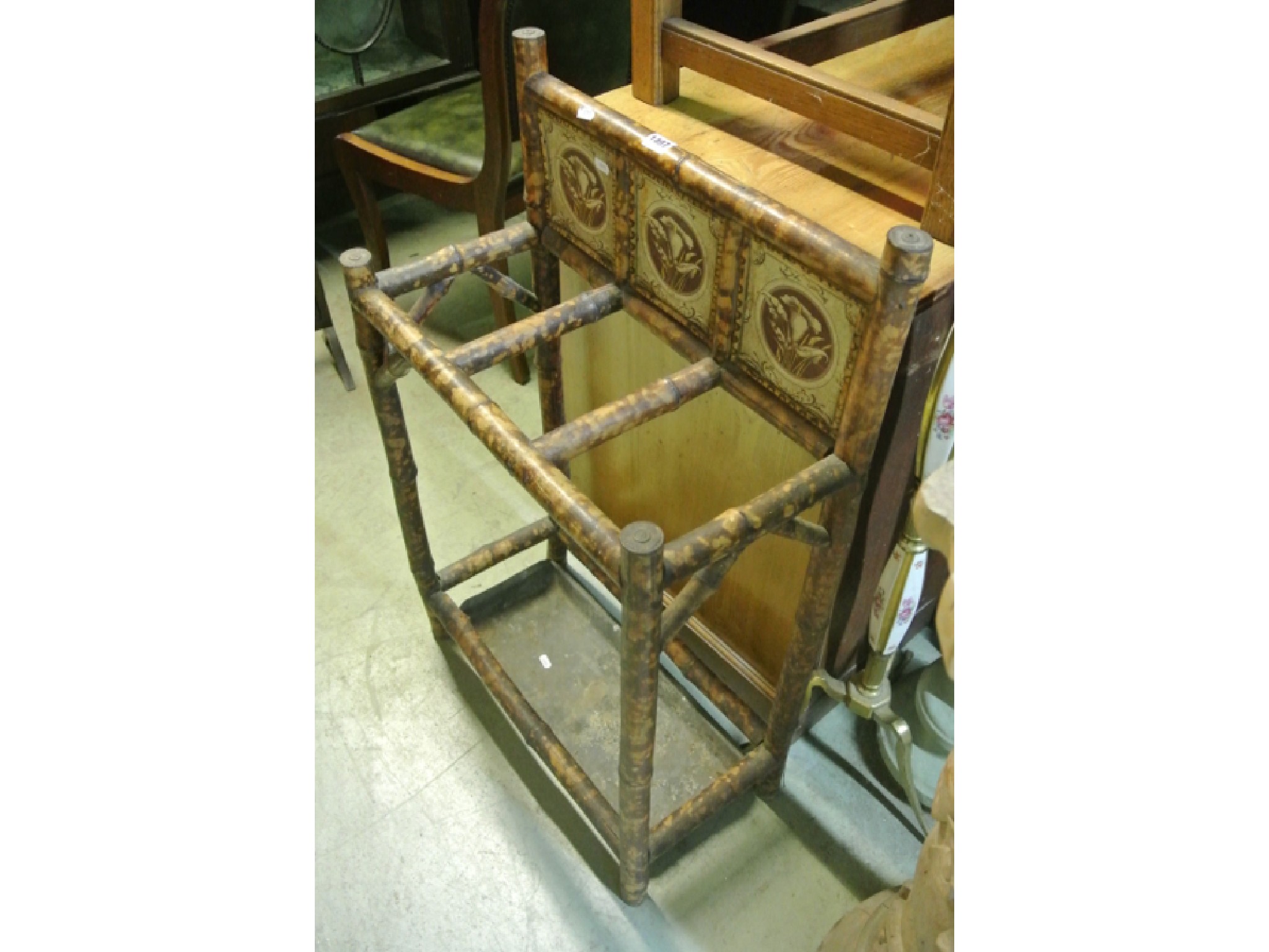 Appraisal: A Victorian bamboo hallstand with printed tin tiled back