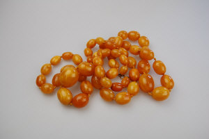 Appraisal: Large graduated two row pressed amber bead necklace to w