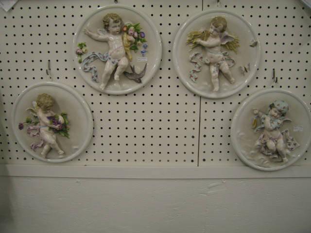 Appraisal: Set of German Porcelain Cherub Plaques high relief th century