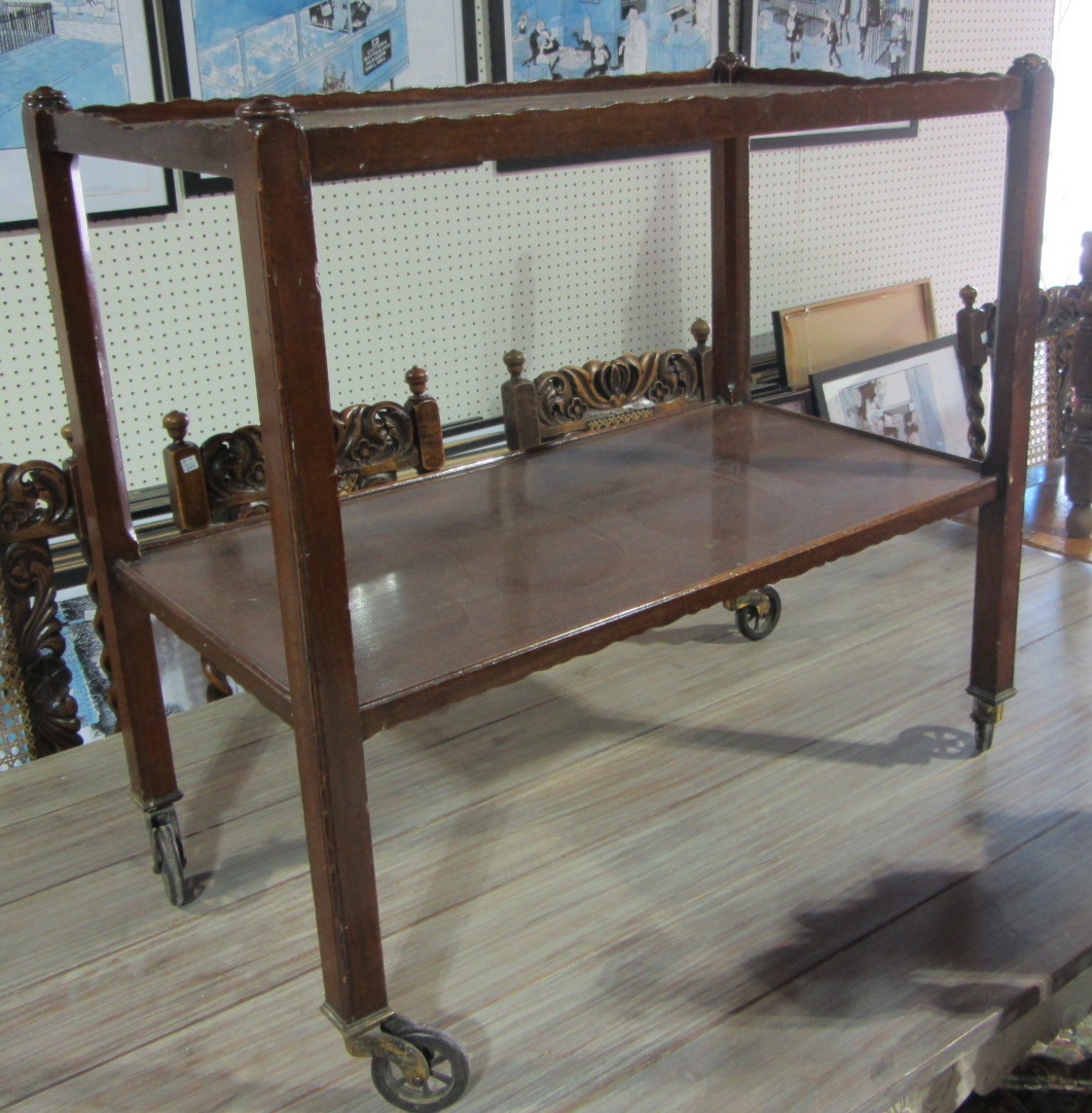 Appraisal: A mahogany two tier trolley and a faux plant